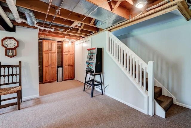 finished below grade area with carpet floors, baseboards, and stairs
