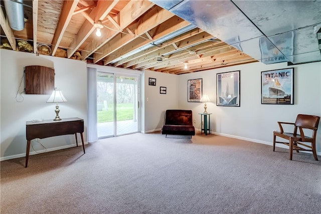 living area featuring baseboards and carpet flooring