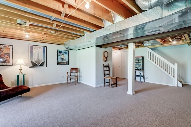 finished basement featuring baseboards, carpet, stairs, and visible vents