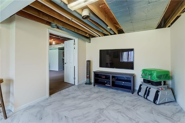 living area featuring baseboards and marble finish floor