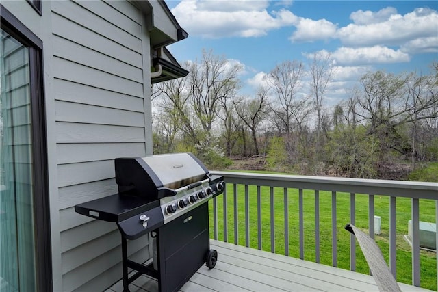 wooden terrace featuring a yard and grilling area