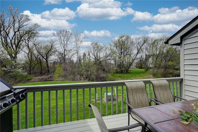 deck featuring a lawn and grilling area