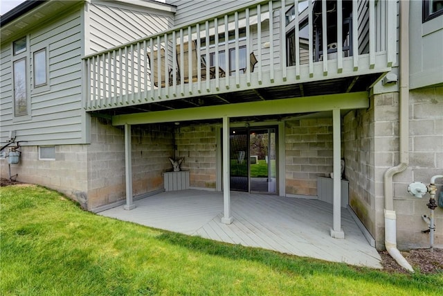 back of property featuring a yard, a deck, and a patio area