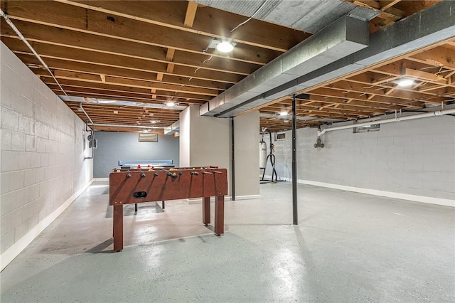 unfinished basement featuring concrete block wall