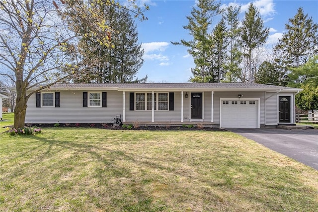 ranch-style house featuring an attached garage, a front lawn, and aphalt driveway