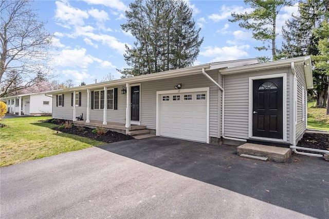 ranch-style home with a garage, driveway, and a front yard