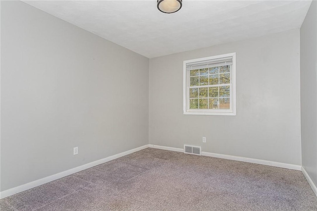 empty room with baseboards, carpet, and visible vents