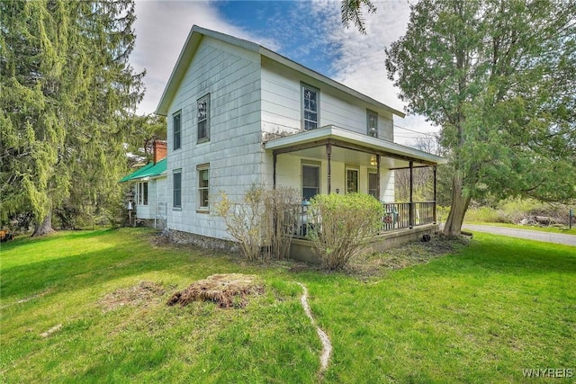 view of property exterior with a porch and a yard