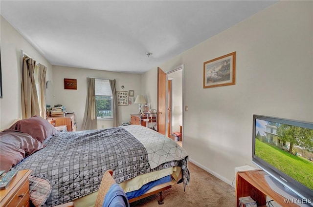 carpeted bedroom featuring baseboards