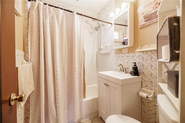 bathroom with vanity, toilet, tile walls, shower / bathtub combination with curtain, and a wainscoted wall
