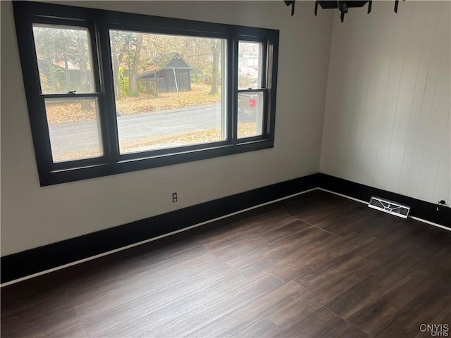empty room with visible vents and dark wood finished floors