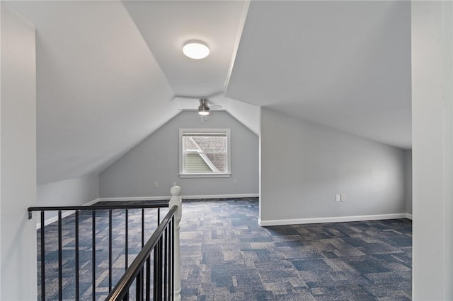 additional living space with carpet floors, ceiling fan, vaulted ceiling, and baseboards