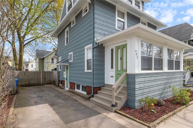 american foursquare style home with fence and entry steps