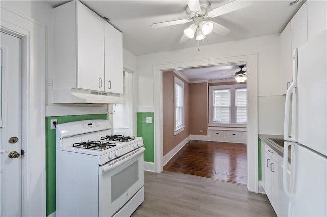 kitchen featuring ceiling fan, light wood-type flooring, under cabinet range hood, white appliances, and white cabinetry