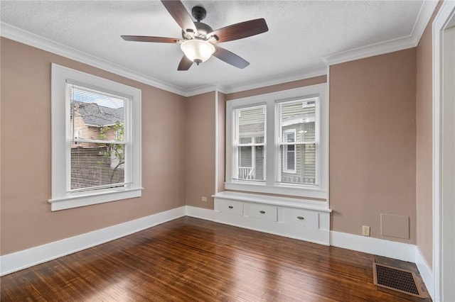 unfurnished room featuring ceiling fan, ornamental molding, baseboards, visible vents, and dark wood-style floors