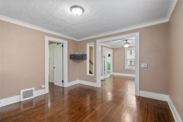 empty room with visible vents, wood finished floors, baseboards, ceiling fan, and a textured ceiling
