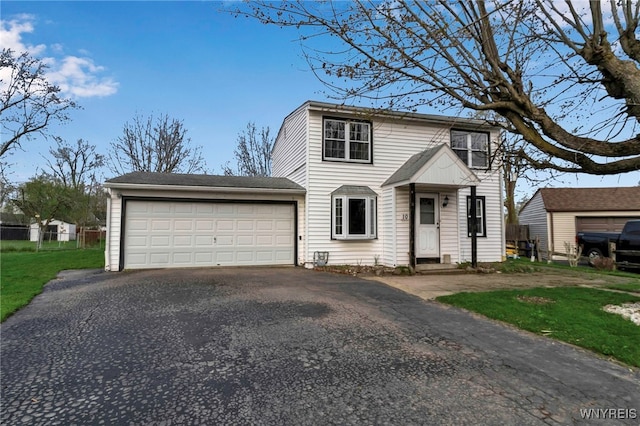 view of front of home with fence, driveway, and a garage