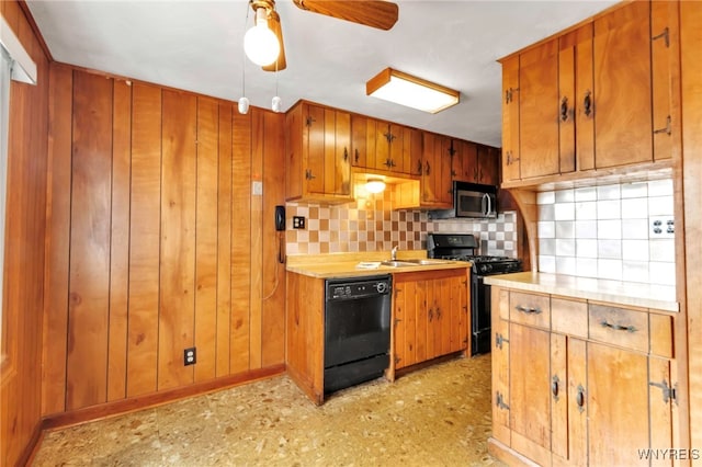 kitchen with brown cabinetry, decorative backsplash, light countertops, a ceiling fan, and black appliances