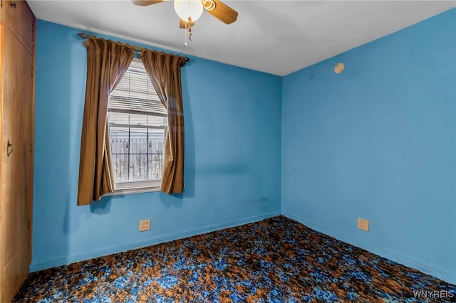 spare room featuring baseboards and a ceiling fan