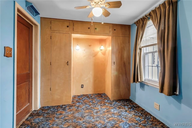 unfurnished room featuring baseboards and a ceiling fan