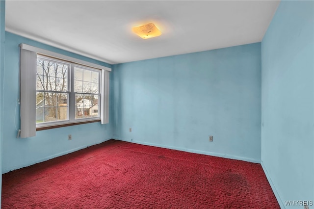 carpeted spare room with baseboards