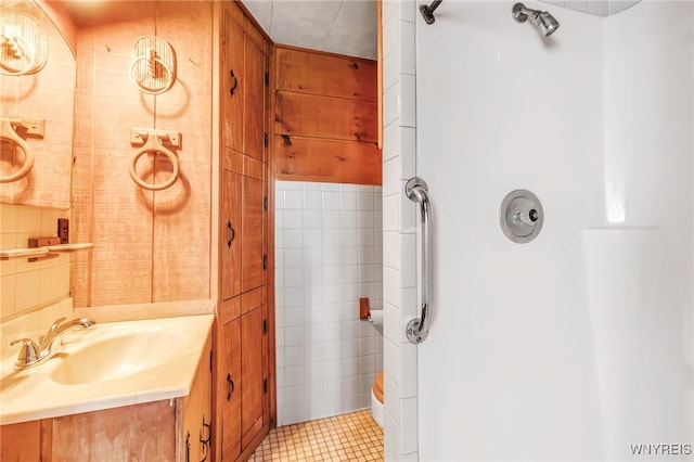 full bathroom featuring walk in shower, tile patterned flooring, and vanity