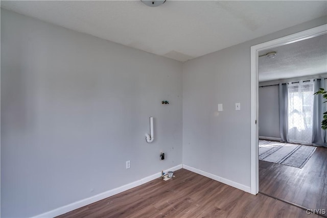 washroom featuring baseboards and wood finished floors