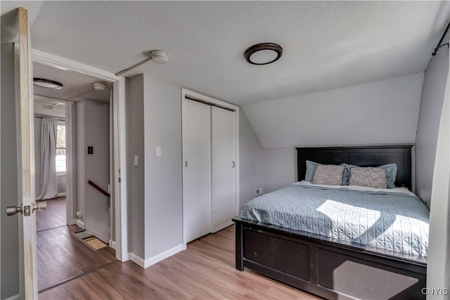 bedroom featuring a closet, a textured ceiling, and wood finished floors
