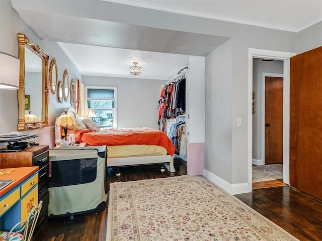 bedroom featuring crown molding, baseboards, and dark wood-style floors
