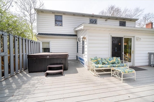 wooden deck featuring a hot tub and outdoor lounge area