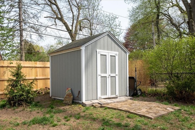 view of shed featuring fence