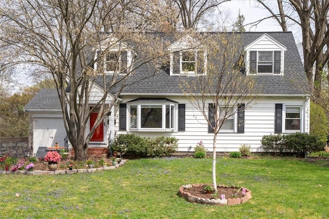 cape cod house with a shingled roof and a front lawn