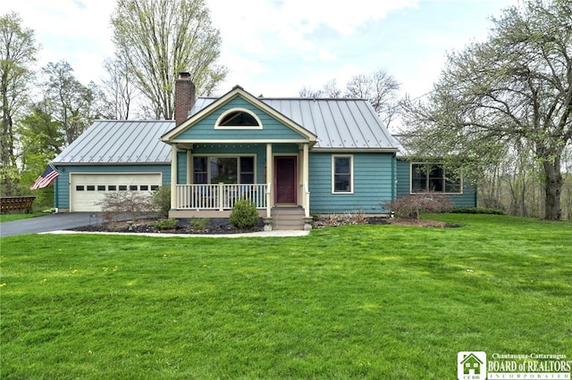 view of front facade with aphalt driveway, a chimney, a standing seam roof, covered porch, and metal roof