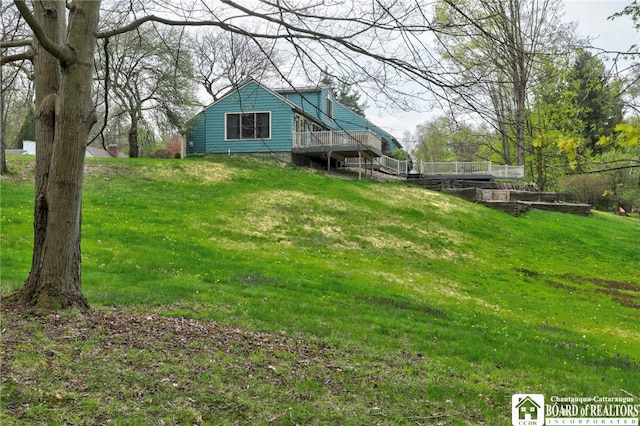view of yard with a garden and a wooden deck