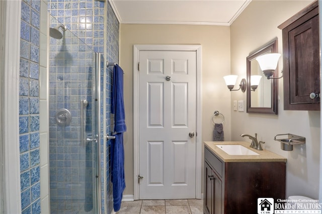 full bath with vanity, ornamental molding, and a stall shower