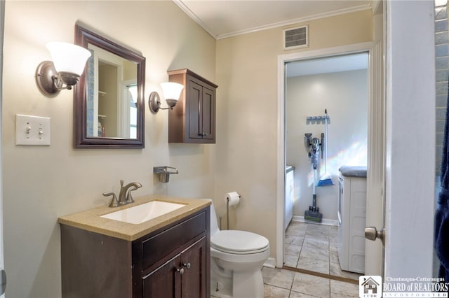 bathroom featuring visible vents, crown molding, vanity, toilet, and washer and clothes dryer