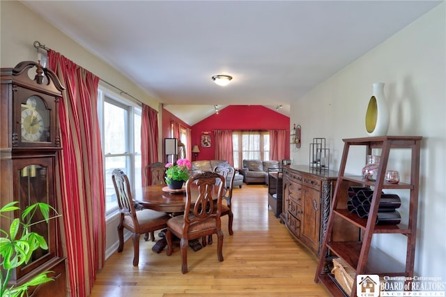 dining room with light wood-type flooring, lofted ceiling, and a wealth of natural light