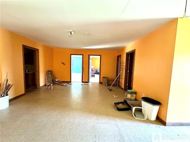 workout room featuring tile patterned floors and baseboards