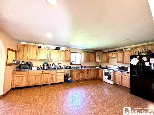 kitchen featuring glass insert cabinets, arched walkways, and black appliances
