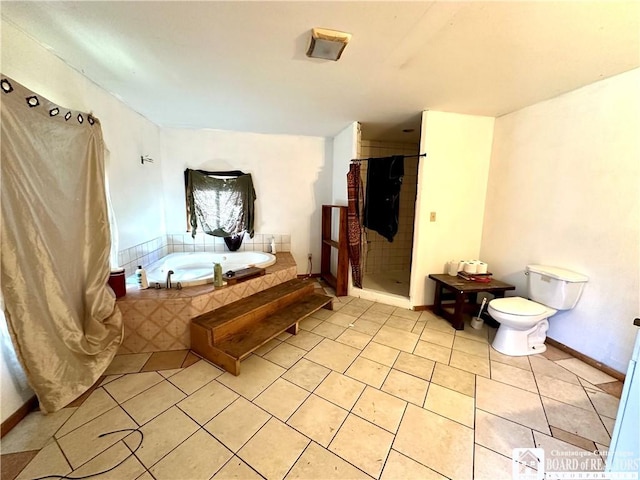 full bathroom featuring a bath, tile patterned flooring, a shower stall, baseboards, and toilet