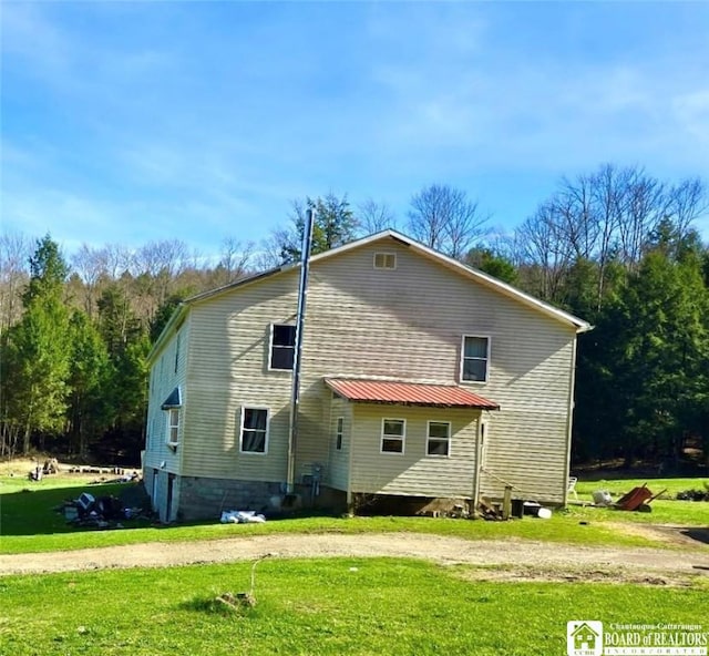 view of home's exterior with a yard
