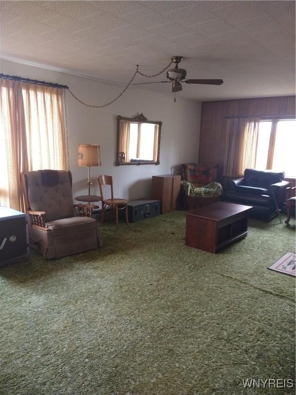 carpeted living room with a ceiling fan