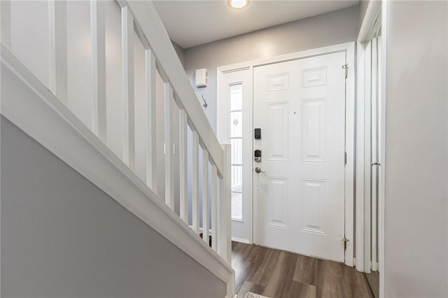 foyer entrance featuring stairway and wood finished floors