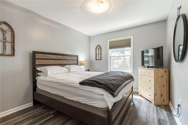 bedroom with baseboards and dark wood-style floors