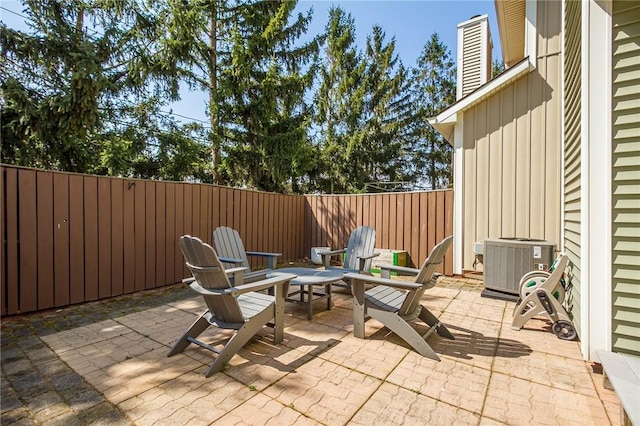 view of patio with a fenced backyard and central AC