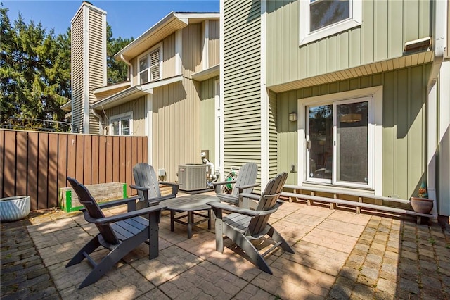 view of patio with fence and central AC