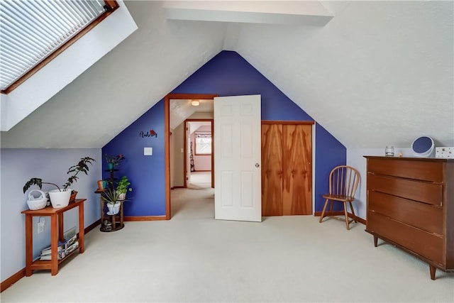 additional living space with carpet flooring, baseboards, and lofted ceiling