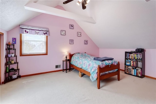 carpeted bedroom with visible vents, a ceiling fan, baseboards, and vaulted ceiling