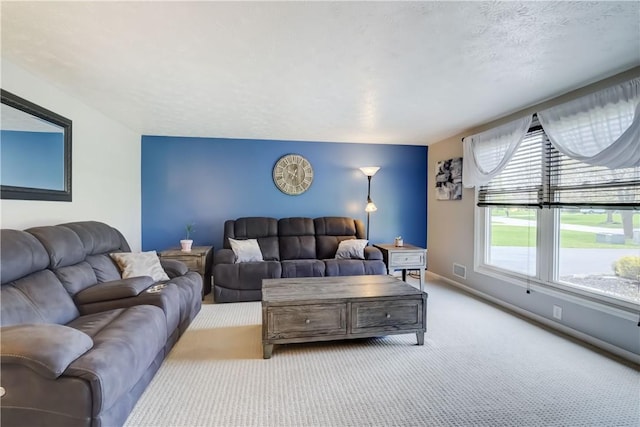 carpeted living room featuring baseboards and visible vents