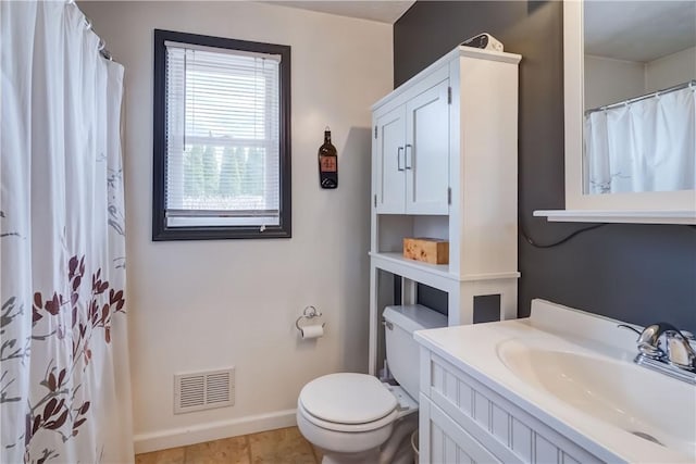 bathroom with toilet, baseboards, visible vents, and vanity